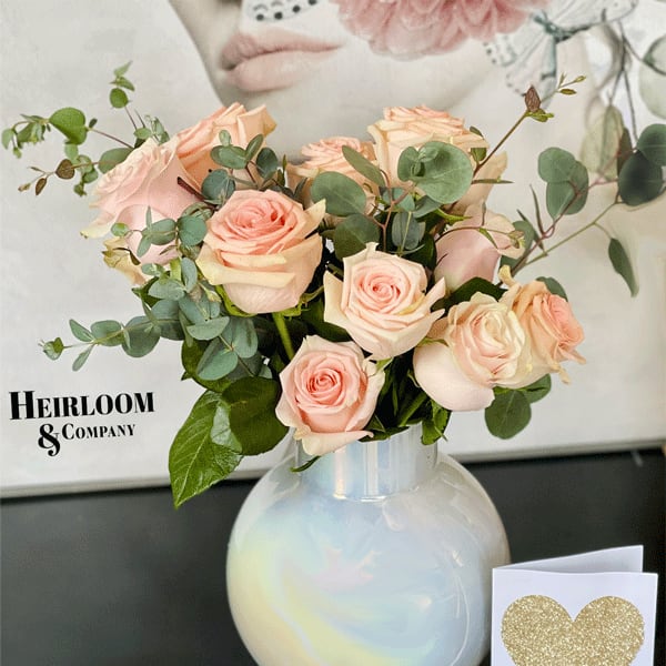 Blush roses in a white vase with a glitter heart card