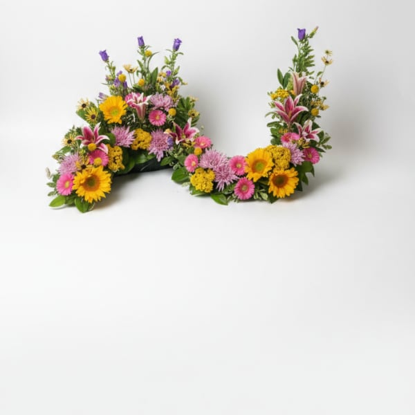 Two colorful floral arrangements shaped like the letter U on a white background