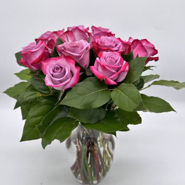 Pink roses arranged in a clear glass vase