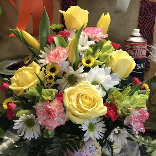 Mixed bouquet of yellow roses, daisies, carnations, and tulips
