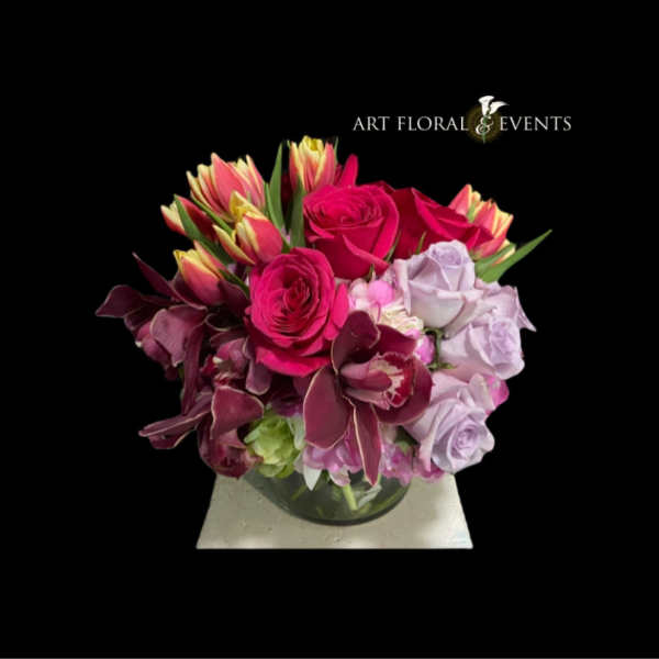 Pink and lavender rose arrangement in a glass vase