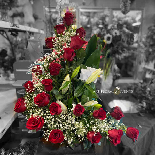 Tall arrangement of red roses with white baby's breath and lilies