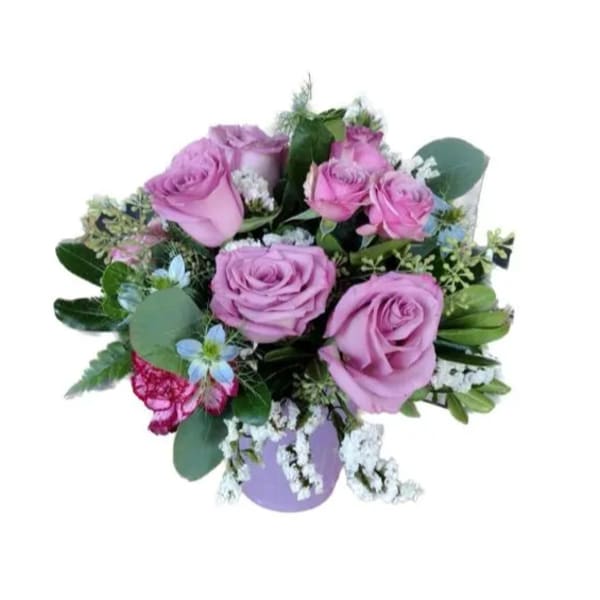 Bouquet of lavender roses with white filler flowers and greenery