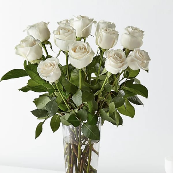 Bouquet of white roses in a clear glass vase