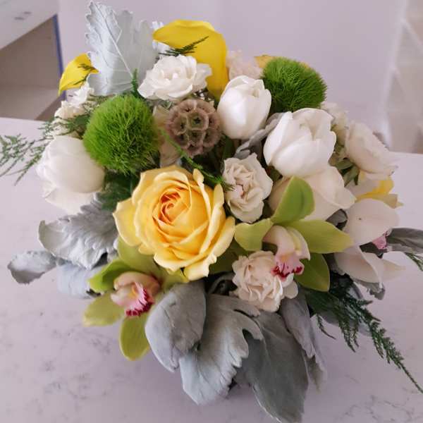 Bouquet of yellow and white flowers with green pom-pom accents