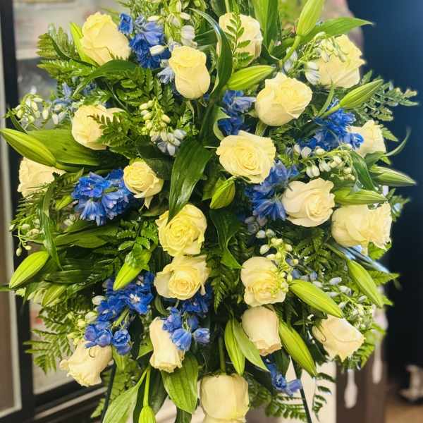 Bouquet of cream roses and blue flowers with lily buds