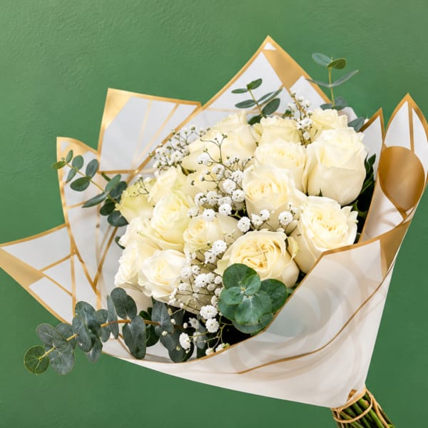Bouquet of cream roses with baby's breath and eucalyptus in white-and-gold wrap