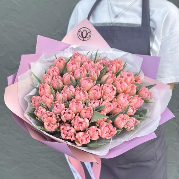 Large bouquet of pink tulips wrapped in pink and white paper