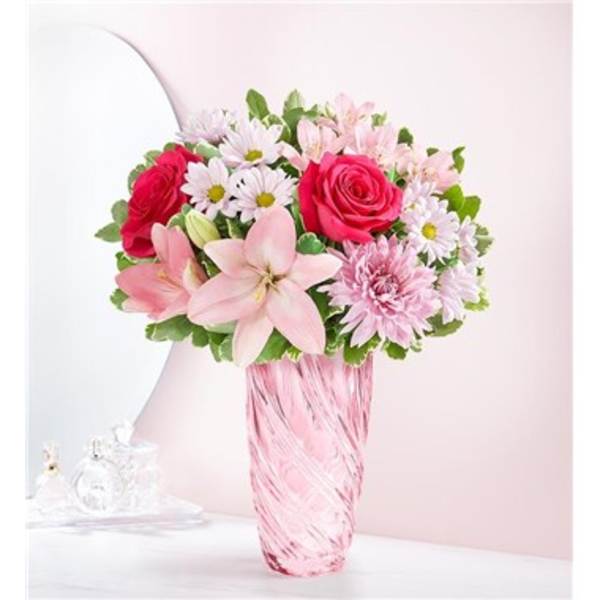 Pink and white mixed bouquet in a pink glass vase