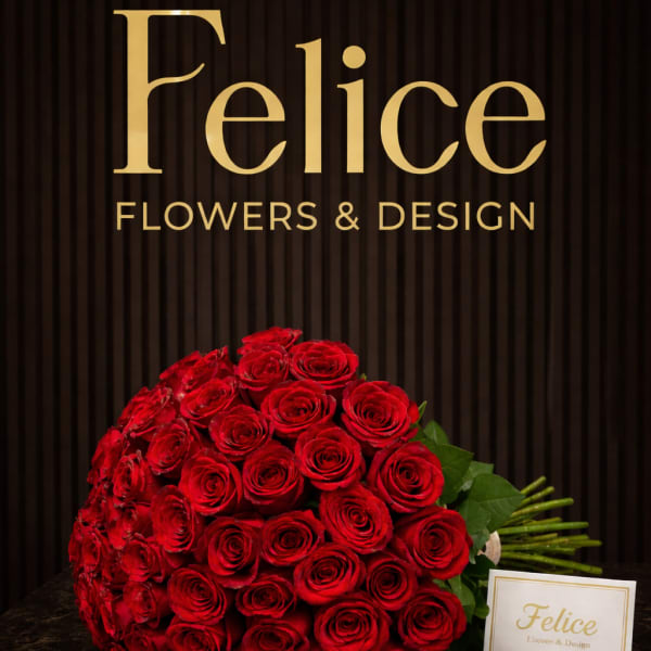 Large bouquet of red roses with a small brand card