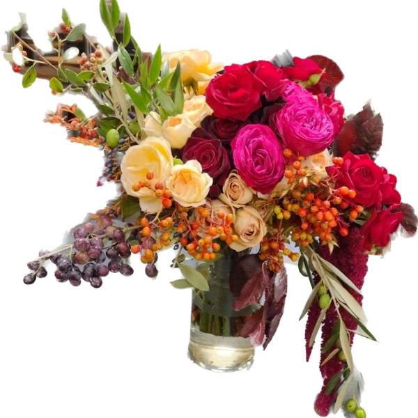 Bouquet of red, pink, and cream roses in a glass vase