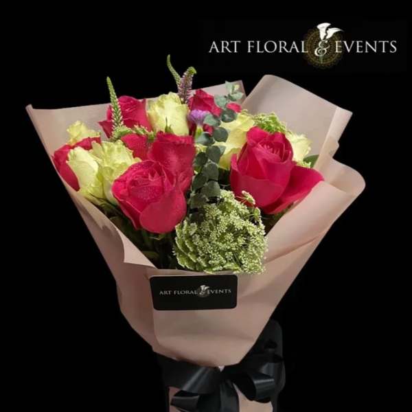Bouquet of pink and pale yellow roses wrapped in blush paper