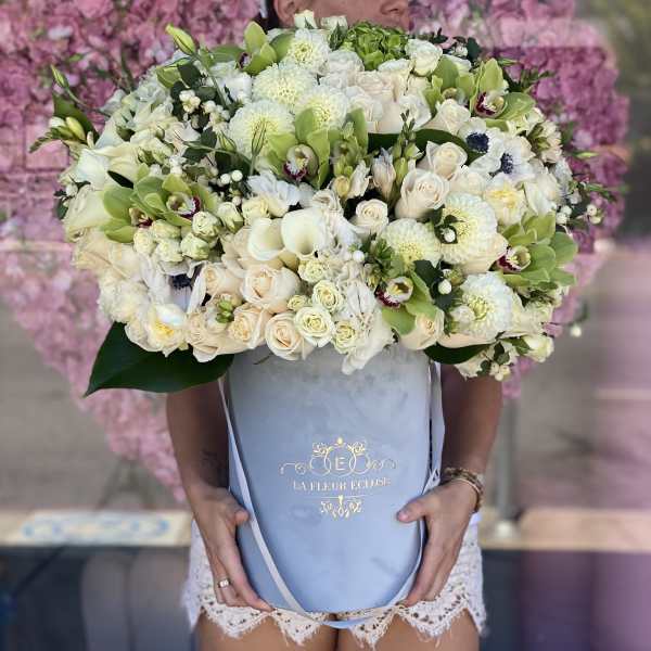 Large bouquet of white and pale green flowers in a blue gift box