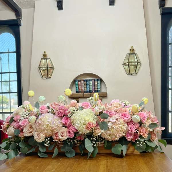 Large pastel floral arrangement with pink and cream roses and hydrangeas