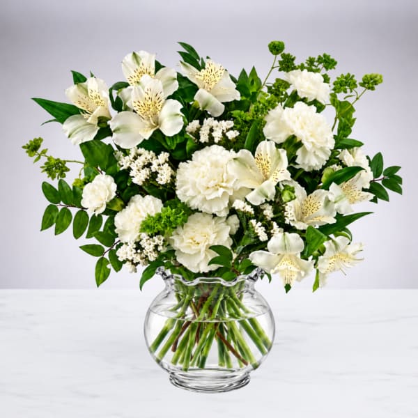 White flowers arranged in a clear glass vase
