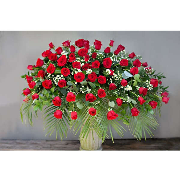 Large arrangement of red roses in a glass vase