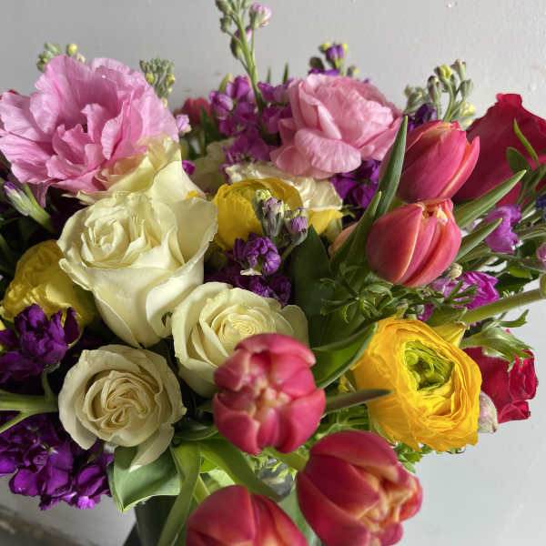 Mixed bouquet with roses, tulips, and pink blooms in bright colors