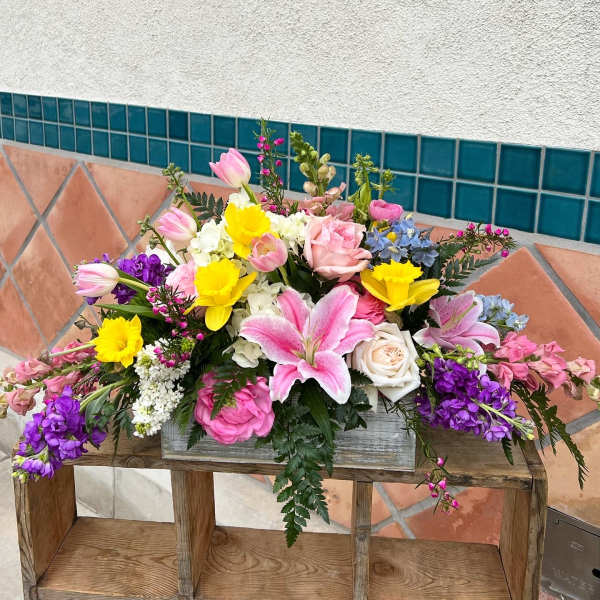 Mixed bouquet with pink tulips, roses, lilies, and yellow daffodils