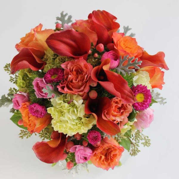Bouquet of red calla lilies and mixed pink-orange flowers