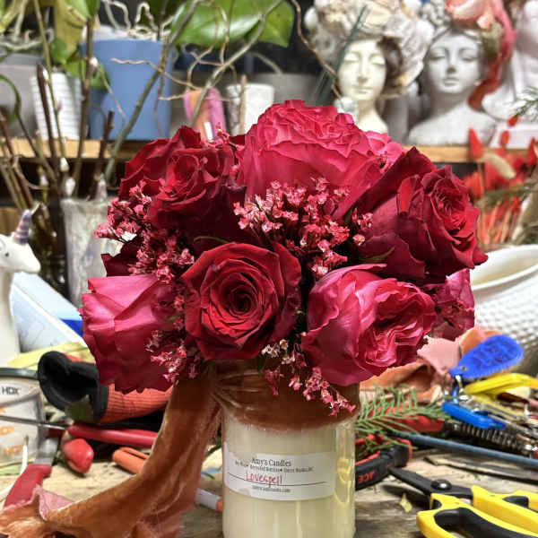 Bouquet of red and pink roses in a glass jar vase