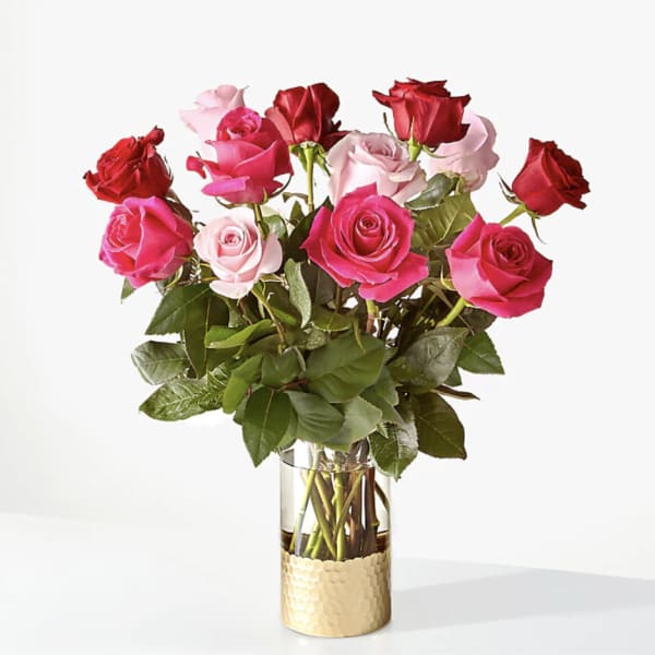 Bouquet of pink and red roses in a clear glass vase