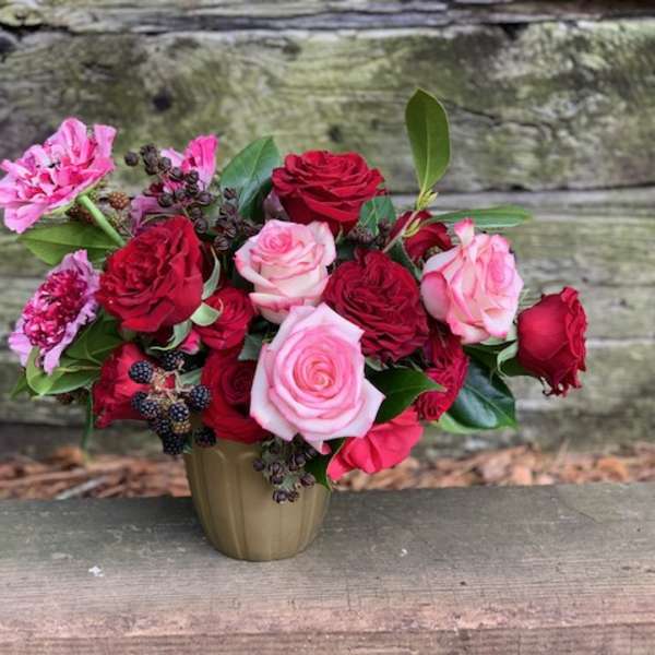 Bouquet of red and pink roses in a small vase