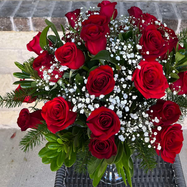 Bouquet of red roses with white baby's breath and greenery