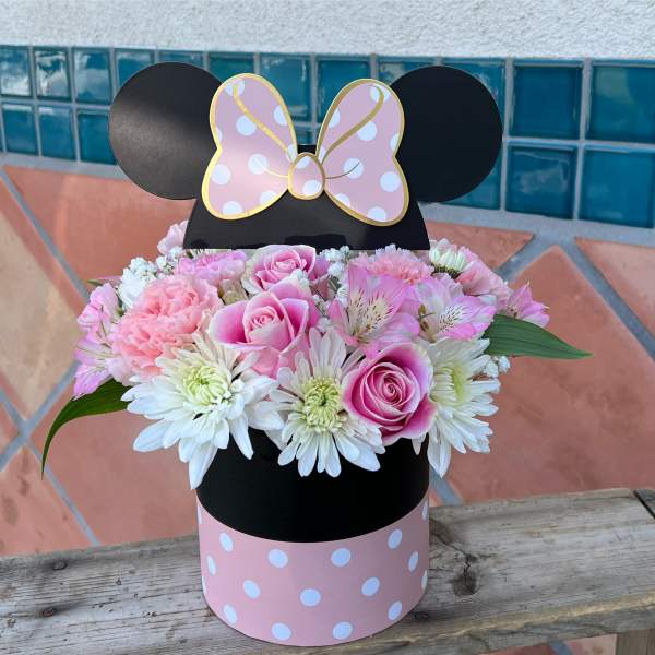 Pink and white flower arrangement in a Minnie Mouse box