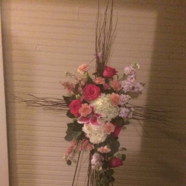 Tall floral standing arrangement with pink and white blooms on a metal easel