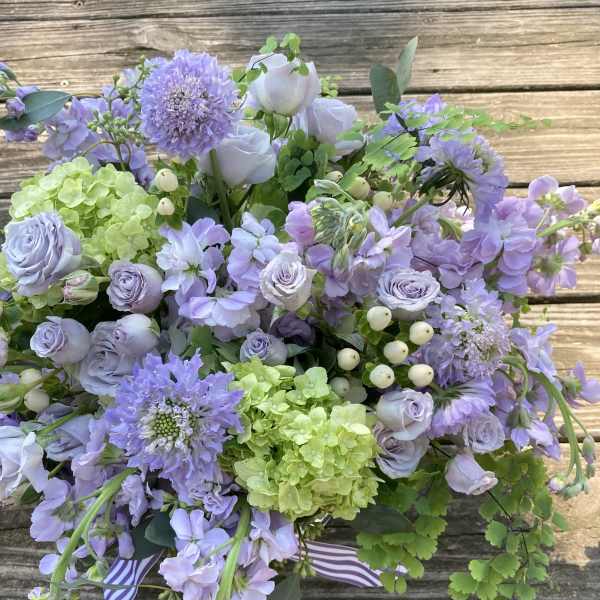 Lavender bouquet with hydrangeas, roses, and purple blooms