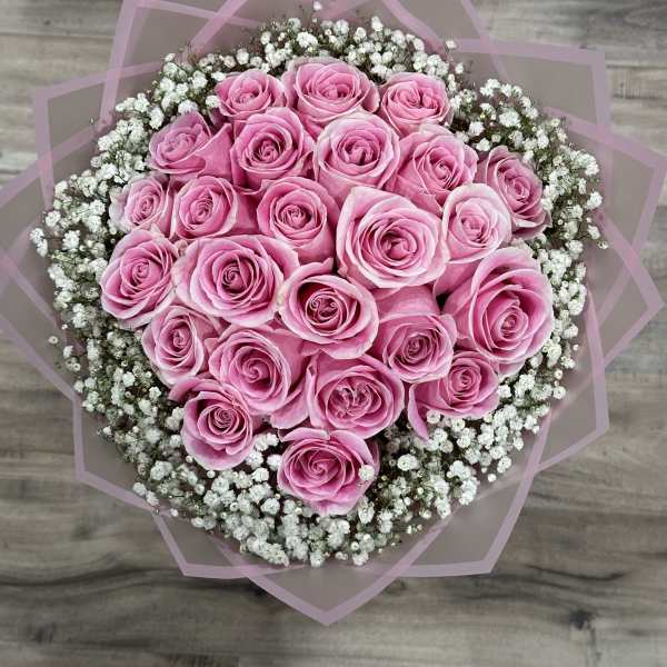 Round bouquet of pink roses with white baby's breath