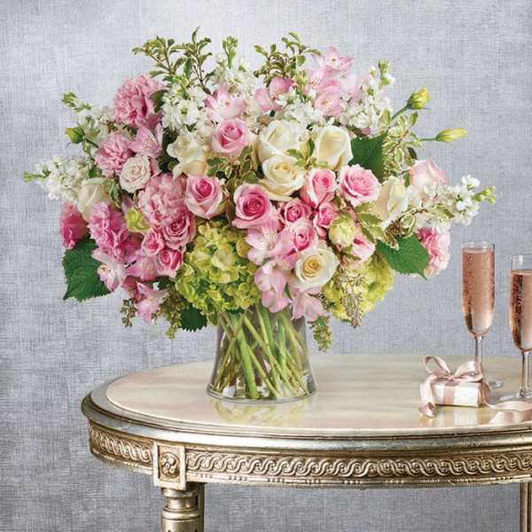 Pink and white mixed flower arrangement in a clear glass vase