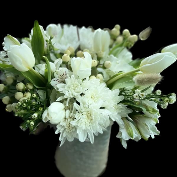 White tulips and chrysanthemums arranged in a vase