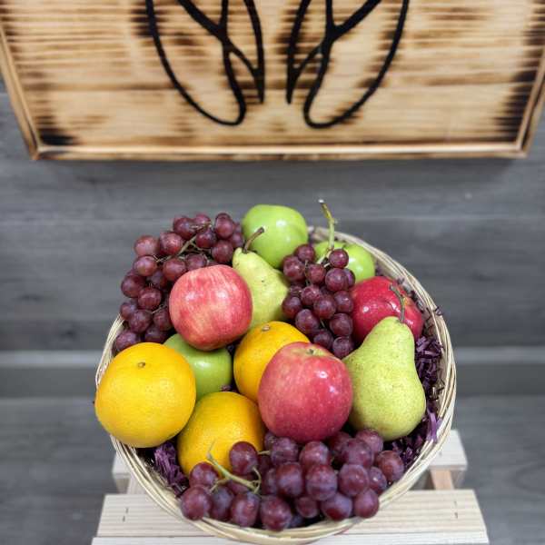 Basket of assorted fruit with grapes, apples, pears, and oranges