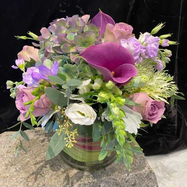 Bouquet of purple and pink flowers in a glass vase
