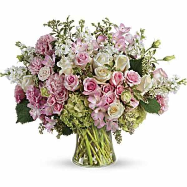 Pink and white rose bouquet in a clear glass vase