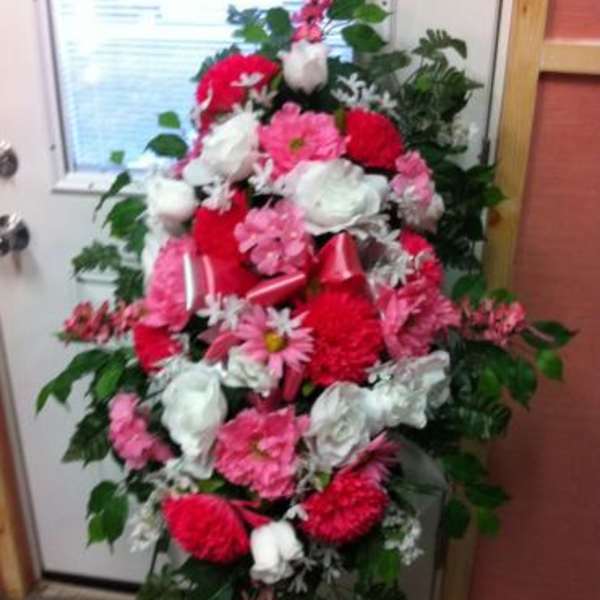 Standing floral spray with pink, red, and white blooms