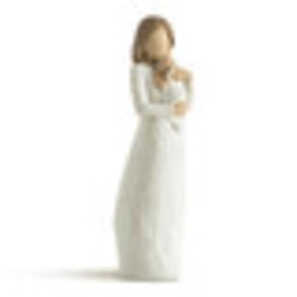 Blurred woman in a long white dress standing against a white background