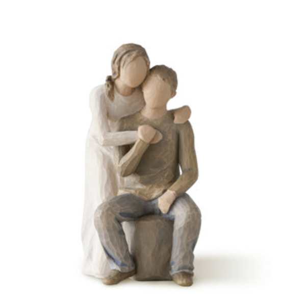 Wooden figurine of two people embracing, seated together