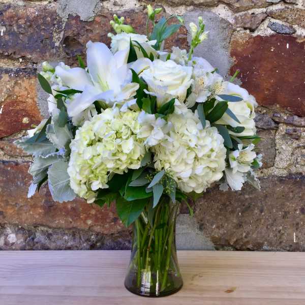 White floral bouquet in a clear glass vase