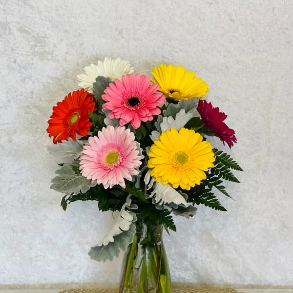 Colorful gerbera daisy bouquet in a clear glass vase