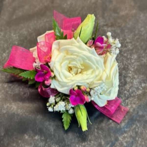 White rose boutonniere with pink accents and ribbon
