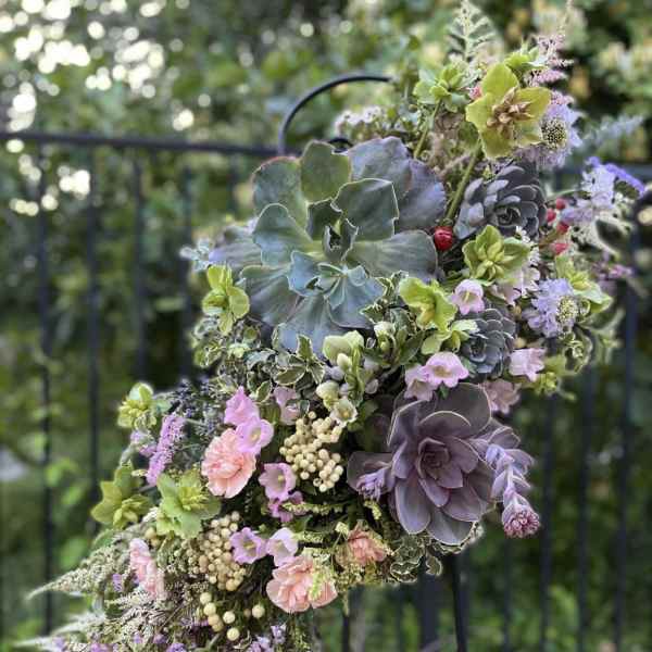 Succulent bouquet with pastel flowers and berries
