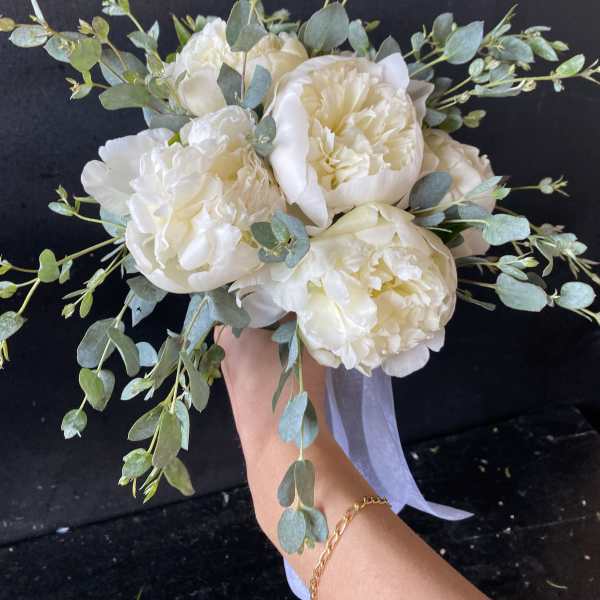White peony bouquet with eucalyptus and a pale ribbon