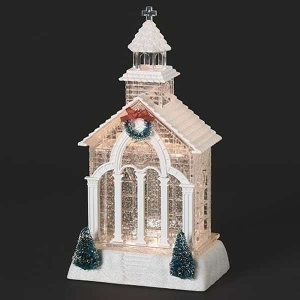 Decorative church-shaped holiday display with lights and small trees