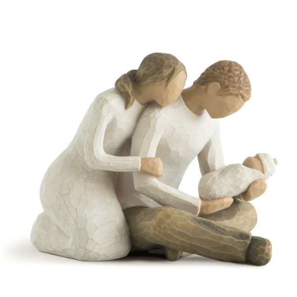 Wooden figurine of two adults with a baby