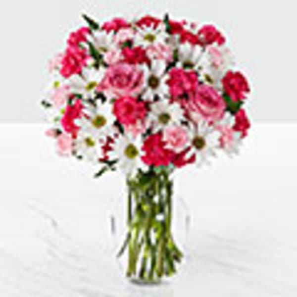 Pink and white mixed bouquet in a clear glass vase