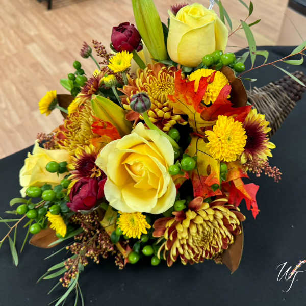 Bouquet of yellow roses and autumn flowers with leaves and berries