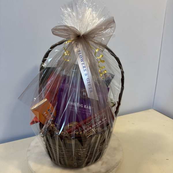 Gift basket wrapped in clear cellophane with a bow