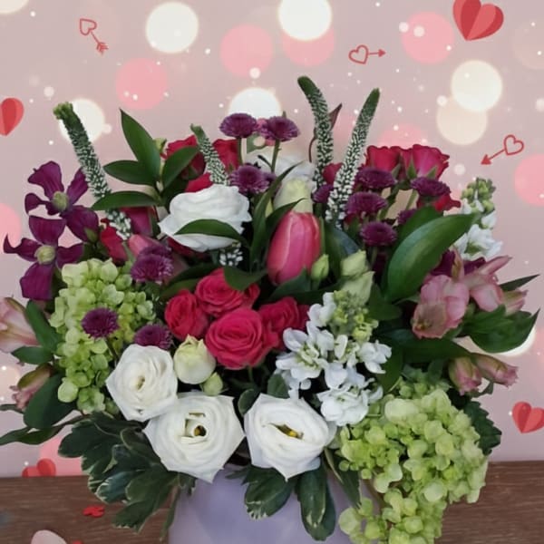 Mixed pink, white, and purple flowers in a round vase